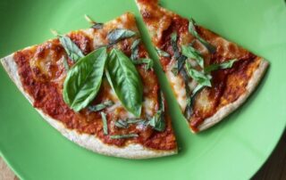 Fresh pizza topped with basil from Wells, Maine