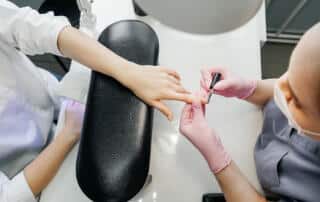 woman getting a manicure at a nail salon in augusta maine