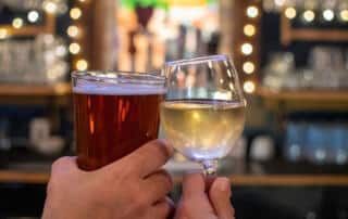 couple toasting drinks in a bar in kittery maine