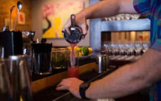 bartender mixing a drink at a bar in wells maine